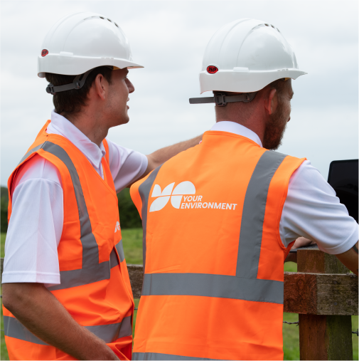 Two site surveyors in high-vis jackets